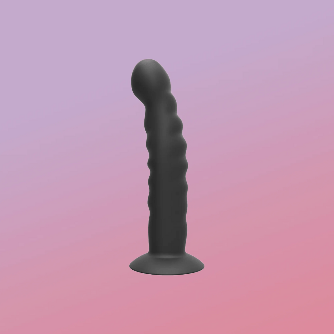 Schwarzer Dildo vor Farbverlauf